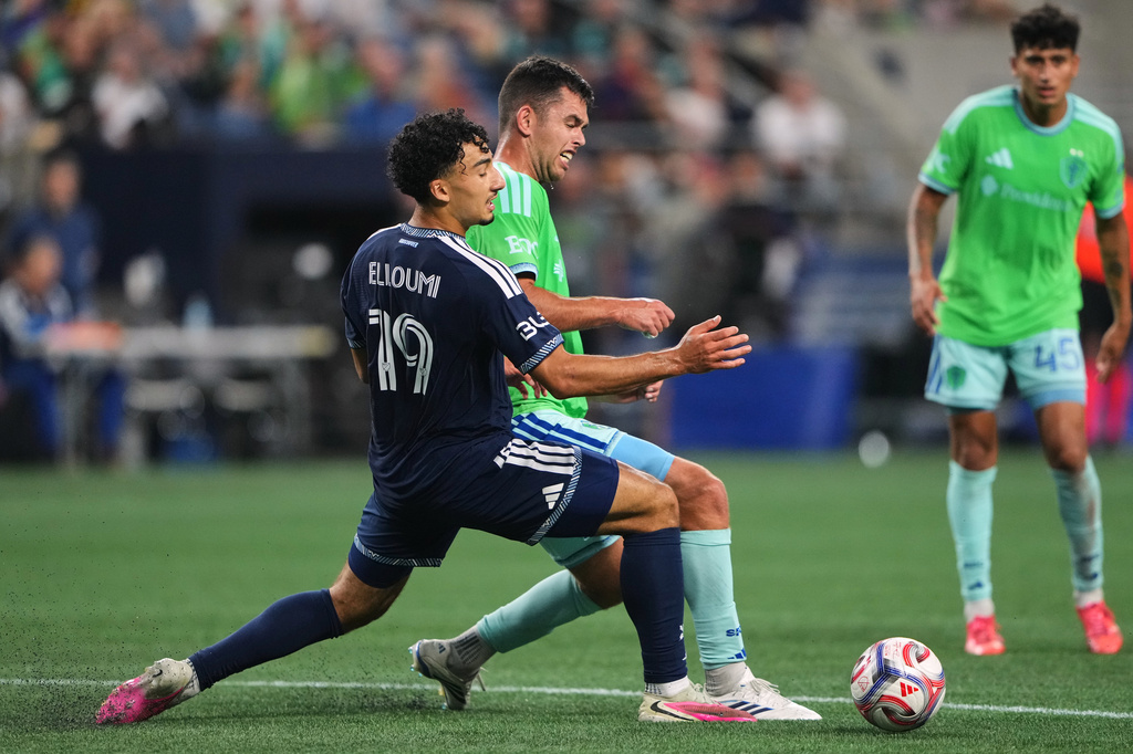 Seattle Sounders defender Jackson Ragen clears the ball from Vancouver Whitecaps forward Rayan Elloumi (19) during the first half of an MLS soccer match, Sunday, Aug. 16, 2026, in Seattle. (AP Photo/Lindsey Wasson)