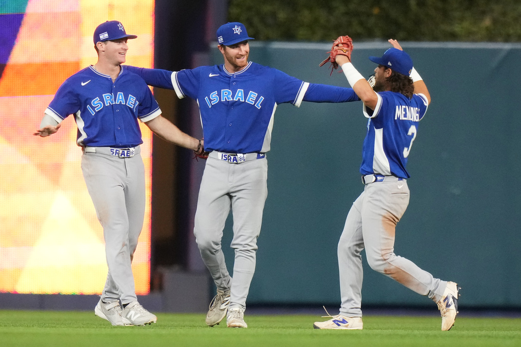 Israel's Zach Levenson, left, RJ Schreck, center, and Noah Mendlinger (3) celebrate after Israel defeated the Netherlands in a World Baseball Classic game, Tuesday, March 10, 2026, in Miami. (AP Photo/Lynne Sladky)