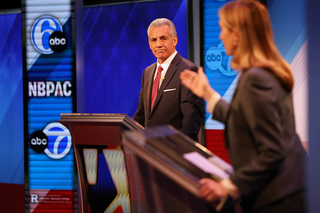 Republican Jack Ciattarelli, left, looks on while Democrat Mikie Sherrill speaks during the final debate in the New Jersey governor's race, Wednesday, Oct. 8, 2025, in New Brunswick, N.J. (AP Photo/Heather Khalifa)