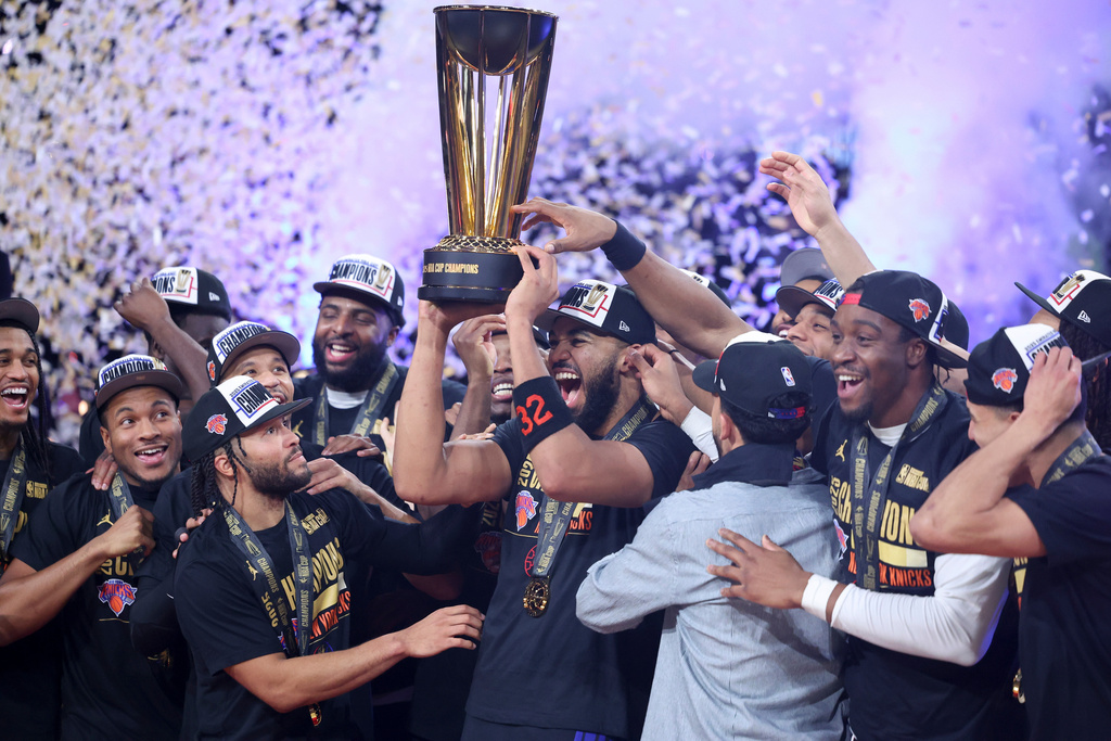 New York Knicks center Karl-Anthony Towns (32) celebrates with teammates after his team's victory against the San Antonio Spurs in the NBA Cup championship basketball game Tuesday, Dec. 16, 2025, in Las Vegas. (AP Photo/Ian Maule)