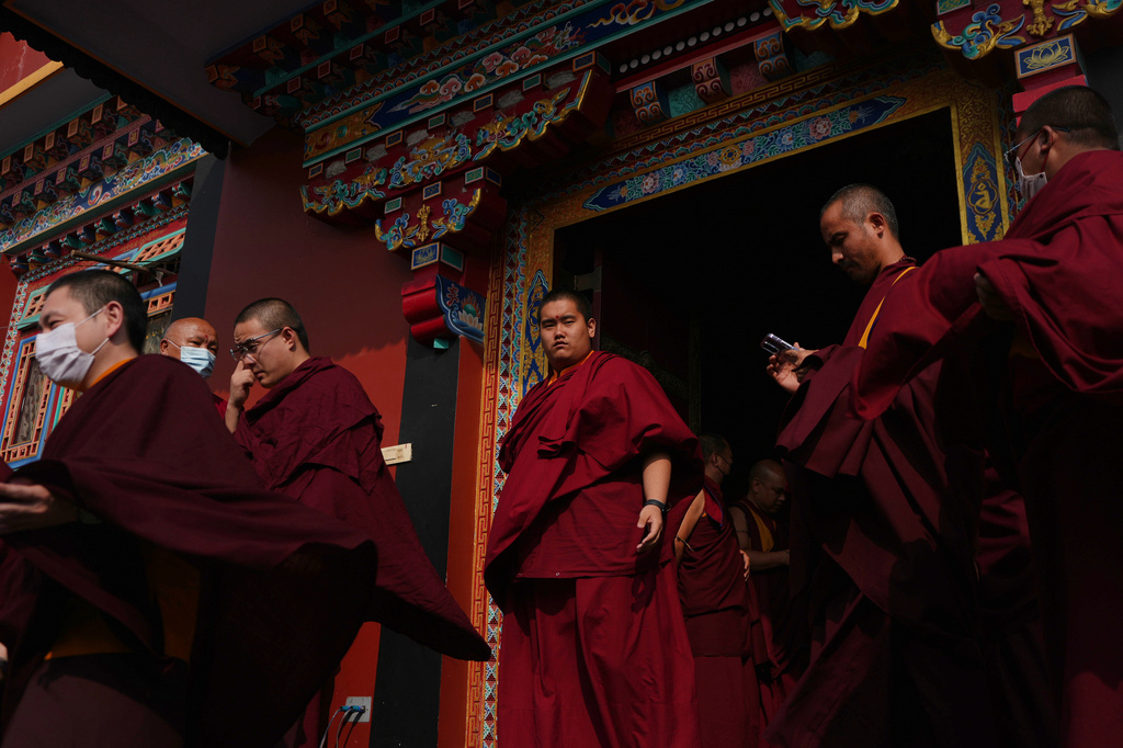 U.S.-born Buddhist lama Jalue Dorje walks out of a prayer hall during a series of rituals and prayers bestowed by the spiritual leader of Shechen Monastery in Kathmandu, Nepal, on Sunday, April 12, 2026. (AP Photo/Luis Andres Henao)