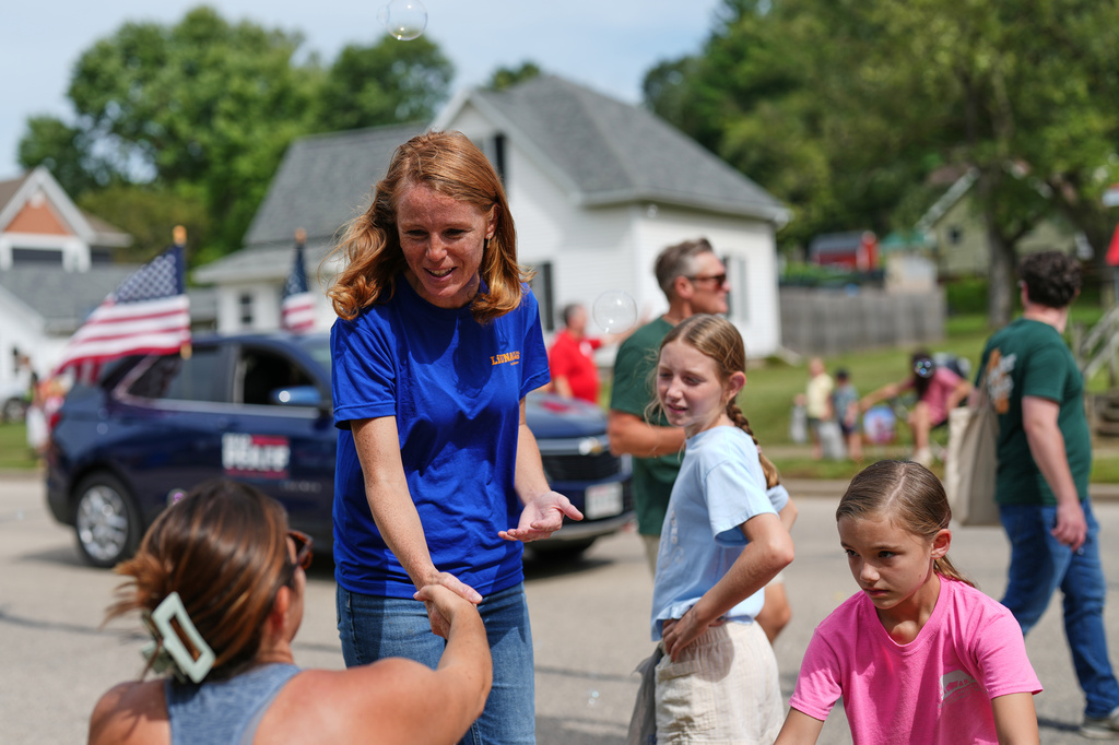Rebecca Cooke, Democratic candidate for Wisconsin's 3rd Congressional District, greets people during a Labor Day parade, Monday, Sept. 7, 2026, in Readstown, Wis. (AP Photo/Ellen Schmidt)