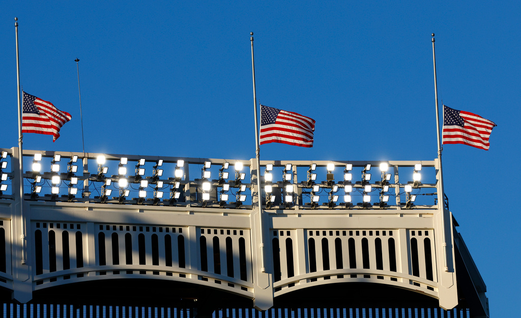 American flags stand at half staff during a 9/11 ceremony before baseball game between the New York Yankees and the New York Mets, Friday, Sept. 11, 2026, in New York. (AP Photo/Noah K. Murray)