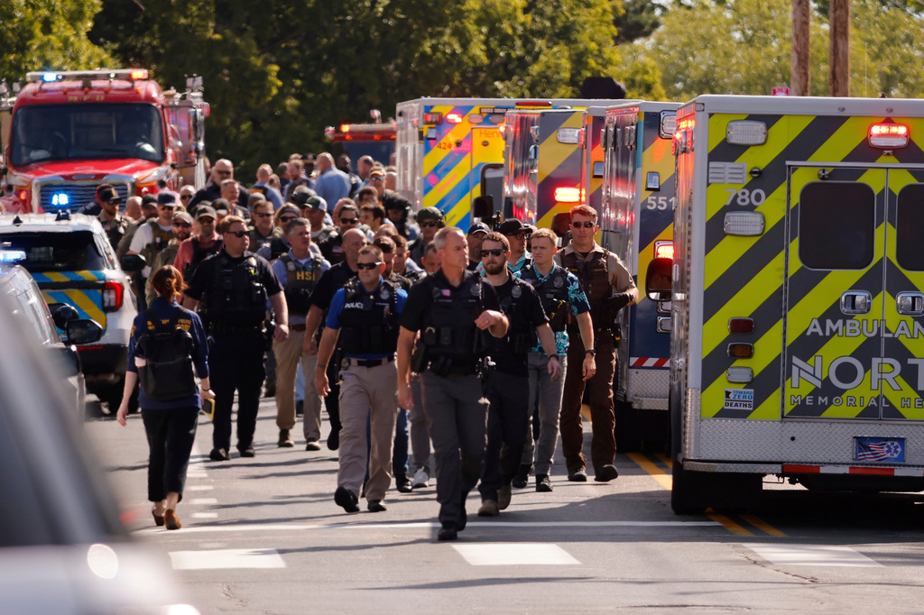 FILE - Law enforcement officers gather outside the Annunciation Church's school in response to a reported mass shooting, Aug. 27, 2025, in Minneapolis. (AP Photo/Bruce Kluckhohn, File)
