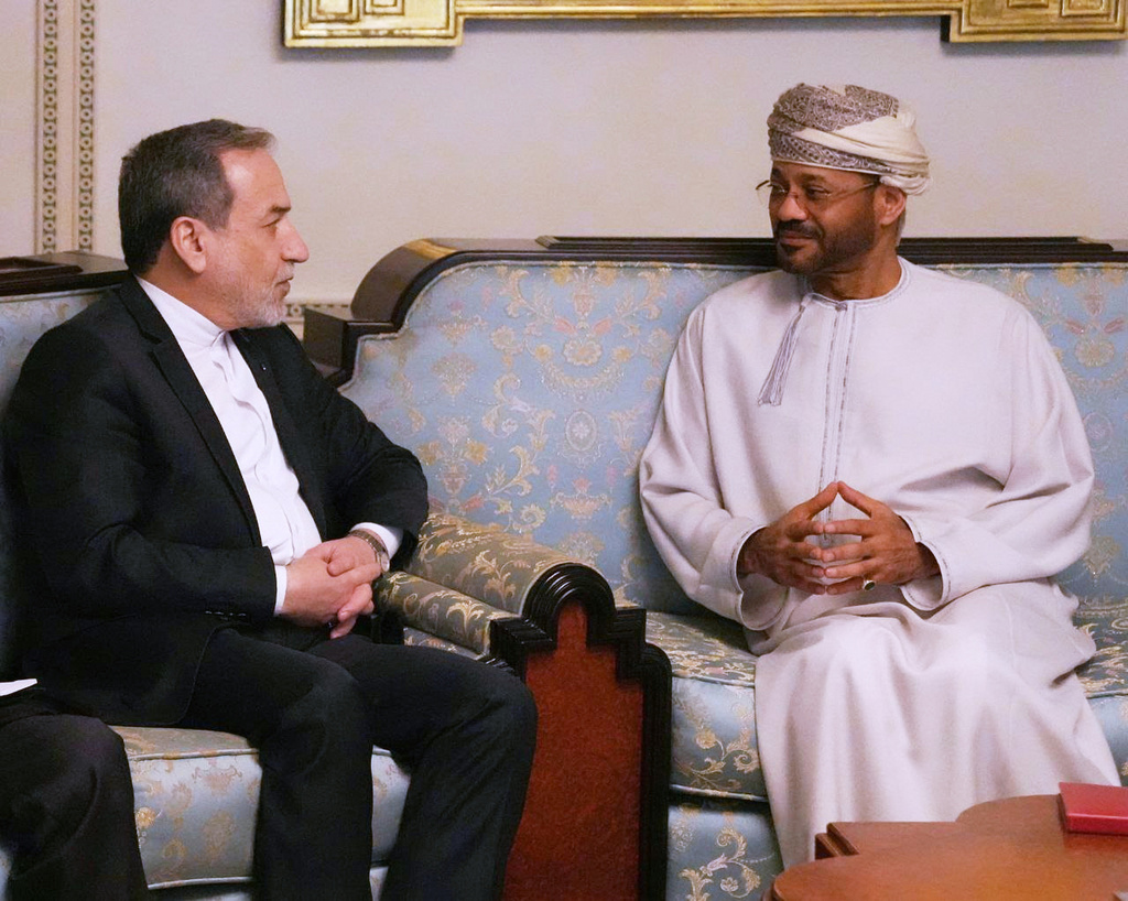 In this photo released by the Iranian Foreign Ministry, Iranian Foreign Minister Abbas Araghchi, left, speaks with his Omani counterpart Sayyid Badr Albusaidi during their meeting prior to Iran and the U.S. negotiations, in Muscat, Oman, Friday, Feb. 6, 2026. (Iranian Foreign Ministry via AP)
