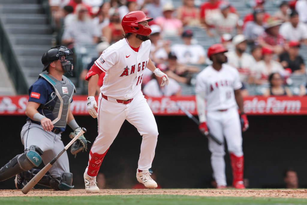 Los Angeles Angels' Nolan Schanuel drops his bat after hitting a sacrifice fly to score Adam Frazier during the 11th inning of a baseball game against the Seattle Mariners, Sunday, April 5, 2026, in Anaheim, Calif. (AP Photo/Jessie Alcheh)