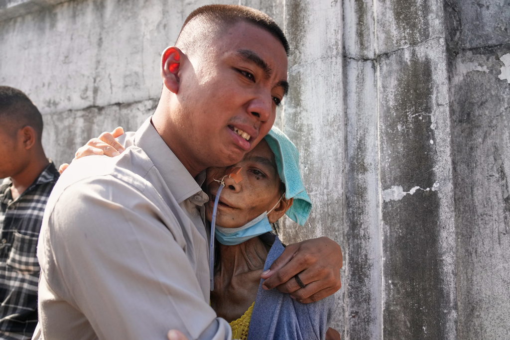 A boy, released from Insein prison, is welcomed by a family member in Yangon, Myanmar, Thursday, Nov. 27, 2025, after Myanmar's military rulers granted a mass amnesty ahead of elections. (AP Photo/Thein Zaw)