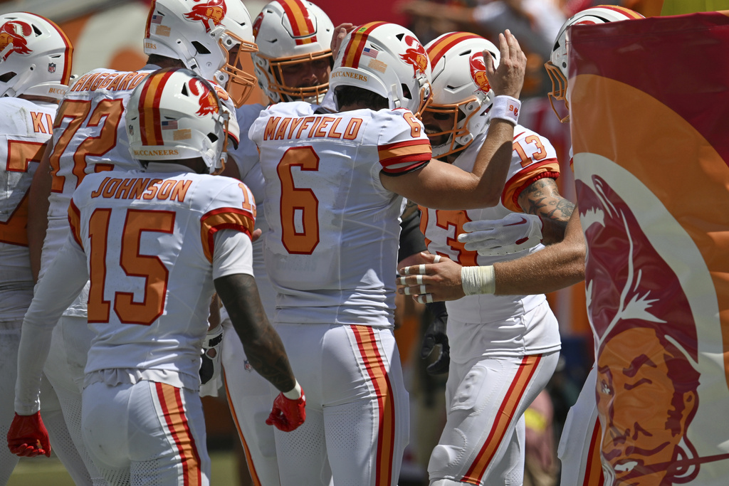 Tampa Bay Buccaneers quarterback Baker Mayfield (6) celebrates with wide receiver Mike Evans (13) after Evans scored a touchdown during the first half of an NFL football game against the New York Jets Sunday, Sept. 21, 2025, in Tampa, Fla. (AP Photo/Jason Behnken)