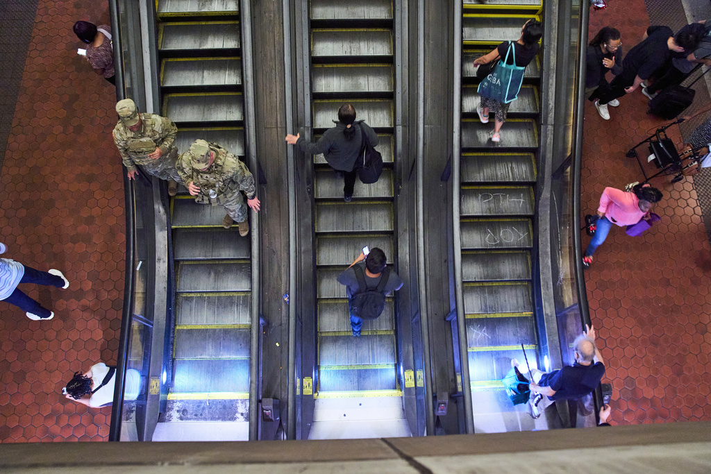 Armed members of the South Carolina National Guard patrol inside the metro system, Tuesday, Aug. 26, 2025, as seen from an overhead level, in downtown Washington. (AP Photo/Jacquelyn Martin)