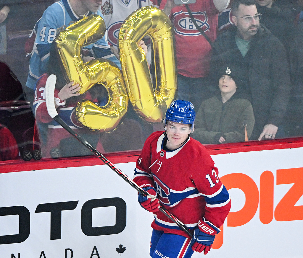 Montreal Canadiens' Cole Caufield (13) skates by the number 50 prior to an NHL hockey game against the New Jersey Devils, in Montreal, Sunday, April 5, 2026. Caufield is one goal away from scoring his 50th for the regular season. (Graham Hughes/The Canadian Press via AP)