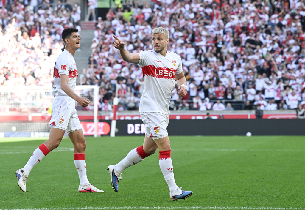 Stuttgart's Ermedin Demirovic, right, celebrates after scoring his side's first goal during the German Bundesliga soccer match between VfB Stuttgart and Werder Bremen in Stuttgart, Germany, Sunday, April 26, 2026. (Bernd Weissbrod/dpa via AP)