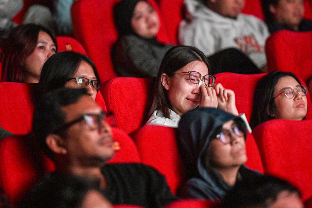 In this photo released by Xinhua News Agency, audience react to the Chinese film "Dear You" during its premiere in Jakarta, Indonesia, on Aug. 5, 2026. (Agung Kuncahya B./Xinhua via AP)