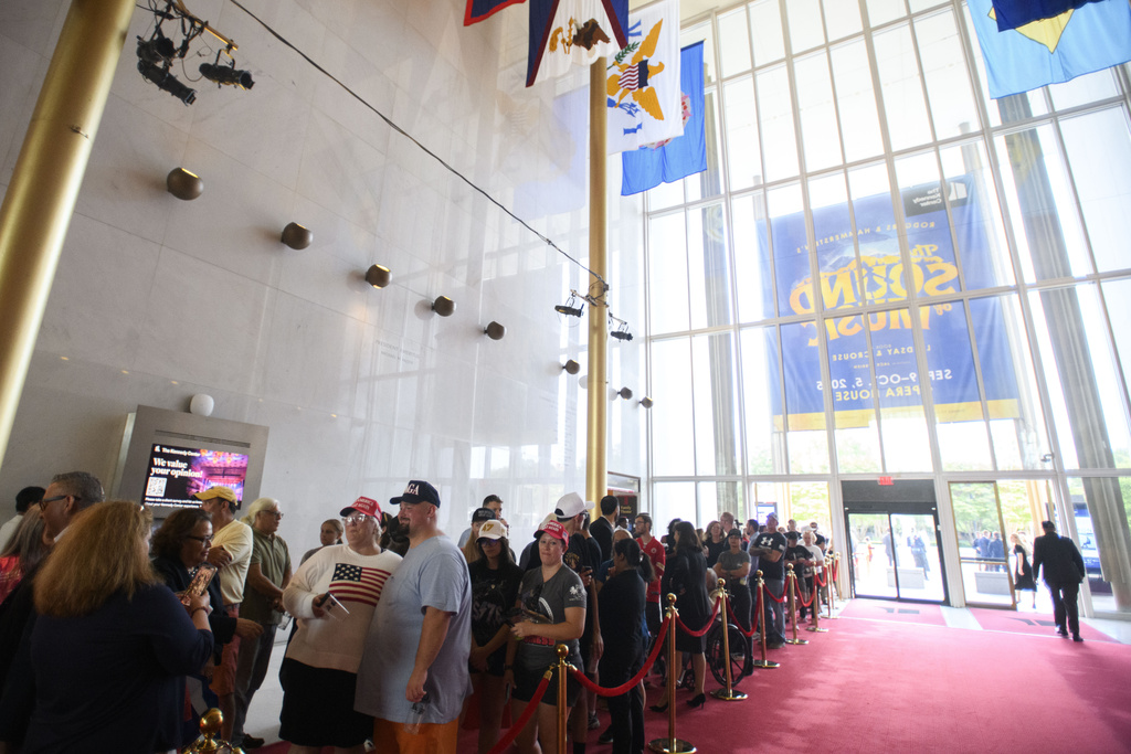 People wait in line for a memorial and prayer vigil for Charlie Kirk at the John F. Kennedy Memorial Center for the Performing Arts, Sunday, Sept. 14, 2025, in Washington. (AP Photo/Rod Lamkey, Jr.)