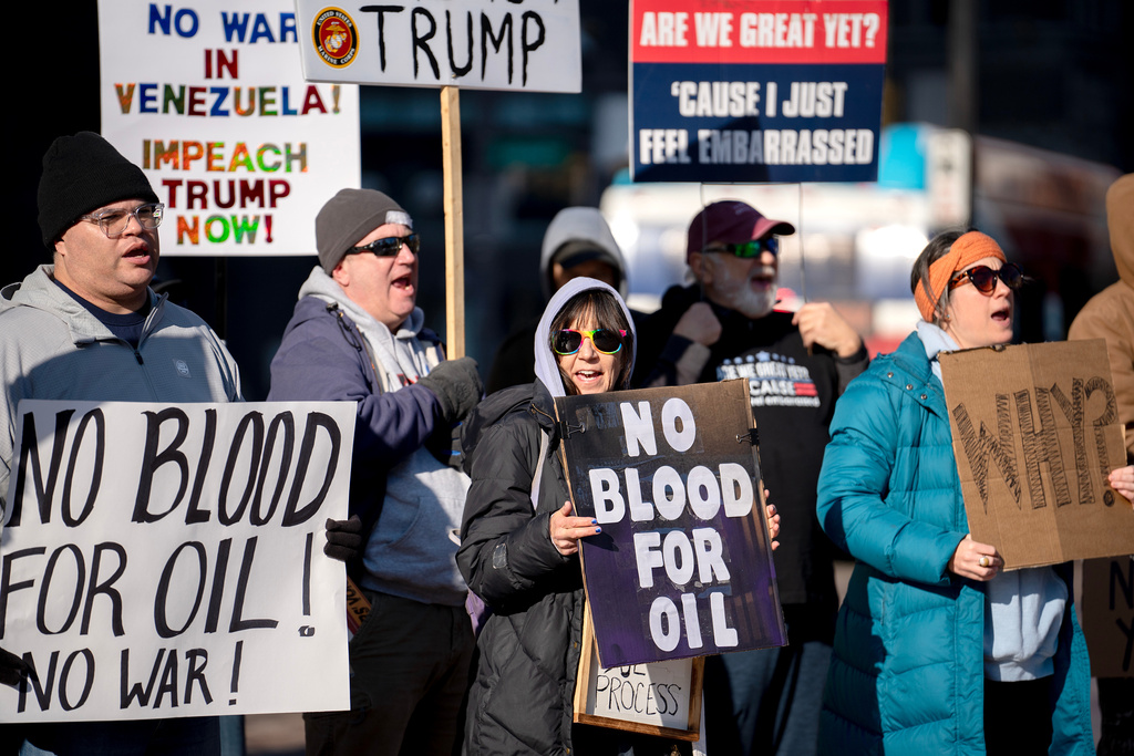 Protesters rally in front of the Ohio Statehouse in Columbus, Ohio, on Sunday, Jan. 4, 2026, after the U.S. captured Venezuelan President Nicolás Maduro and his wife in a military operation. (AP Photo/Jessica Phelps)