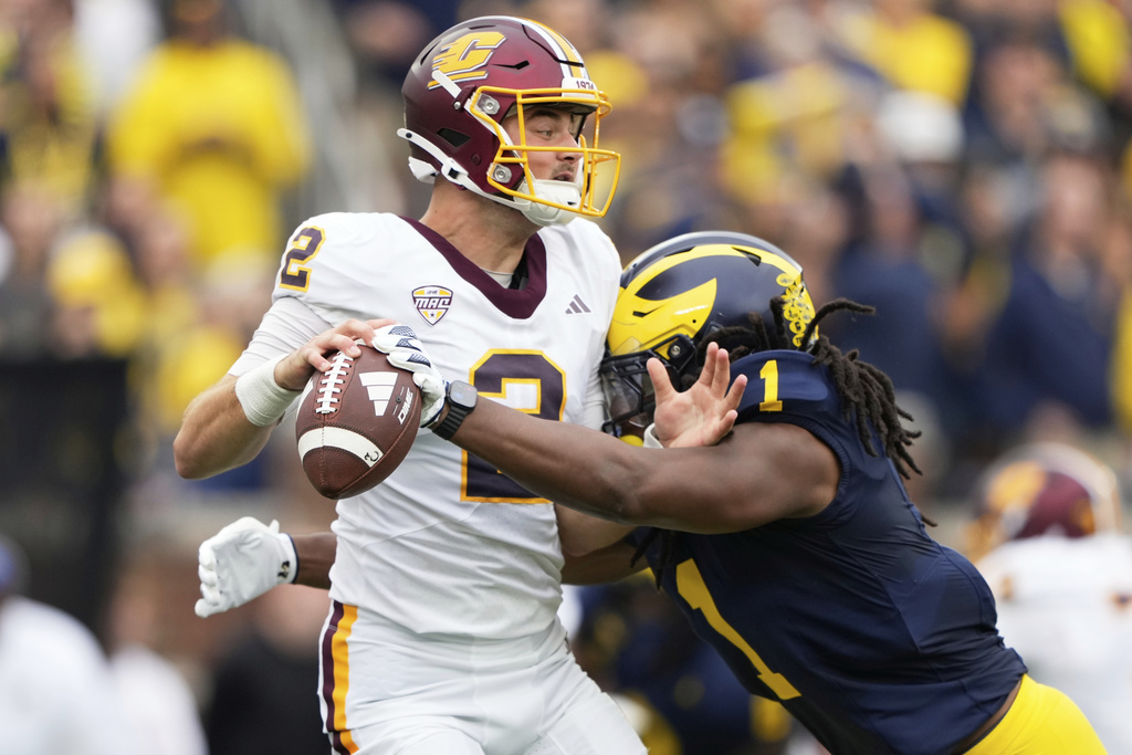 Central Michigan quarterback Joe Labas, left, is sacked by Michigan linebacker Jaishawn Barham during the first half of an NCAA college football game, Saturday, Sept. 13, 2025, in Ann Arbor, Mich. (AP Photo/Ryan Sun)