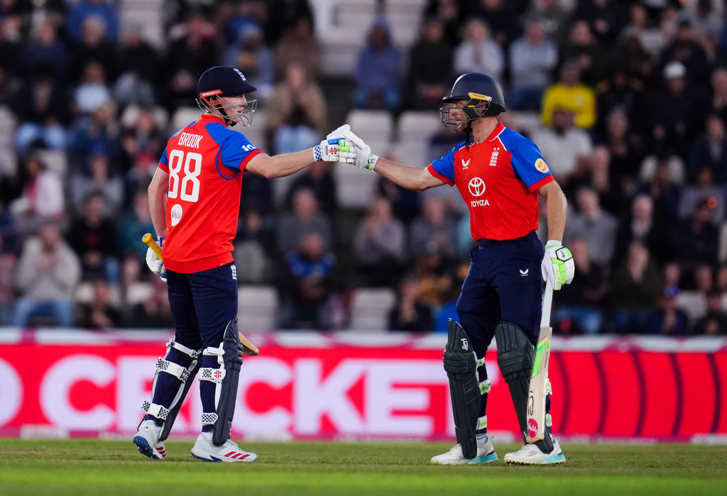 England's Harry Brook, left, celebrates his half century with Jos Buttler during the first IT20 match between England and Sri Lanka in Southampton, England, Tuesday Sept. 15, 2026. (John Walton/PA via AP)