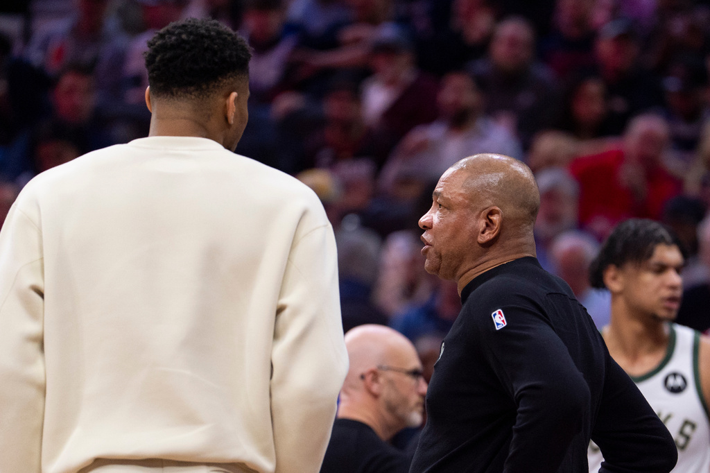Milwaukee Bucks head coach Doc Rivers, front right, talks with power forward Giannis Antetokounmpo, left, during the first half of an NBA basketball game against the Philadelphia 76ers, Sunday, April 12, 2026, in Philadelphia. (AP Photo/Chris Szagola)