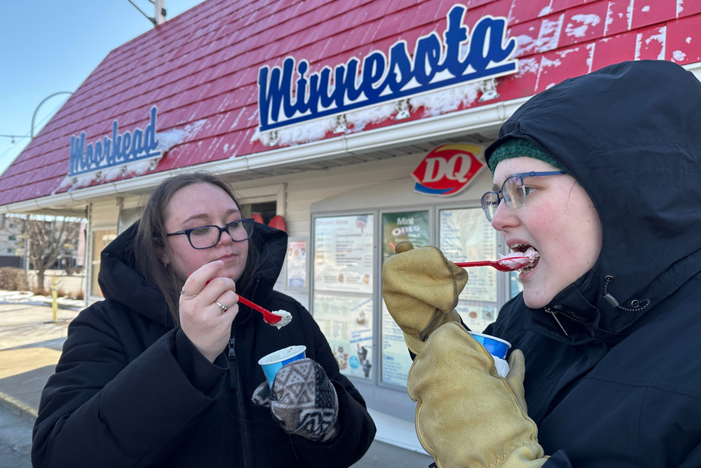 Koral Salisbury, left, and Ally Hoekstra eat ice cream treats Sunday, March 1, 2026, at the Dairy Queen in Moorhead, Minn. (AP Photo/Jack Dura)