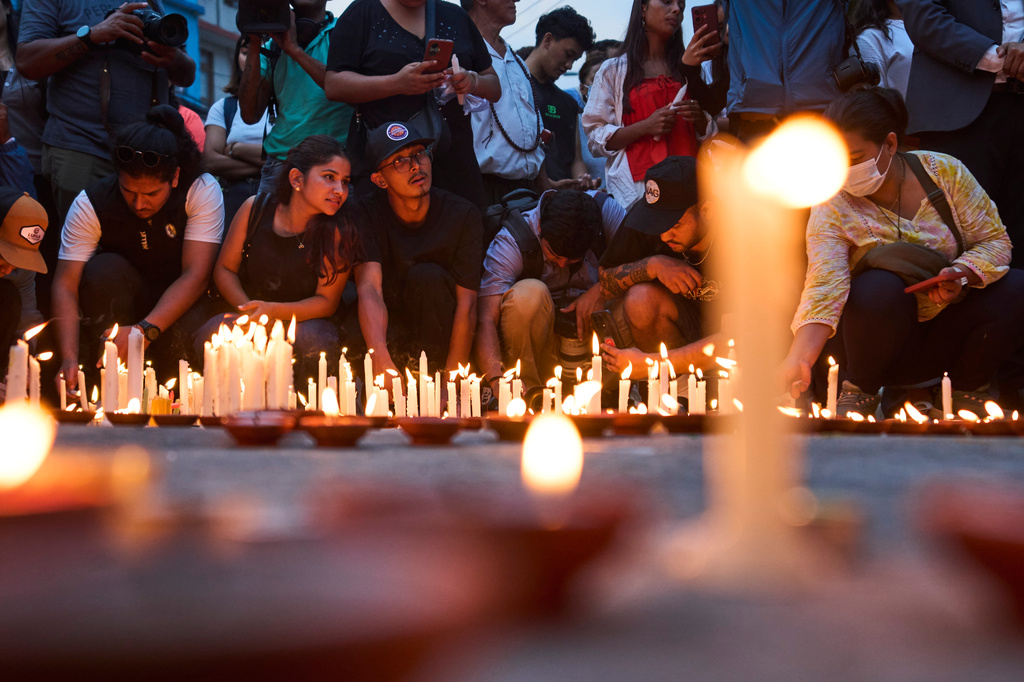 Family members, friends and supporters light candles in memory of the climbers who died Thursday in an avalanche on Pakistan's Broad Peak, Kathmandu, Nepal, Tuesday, Aug. 4, 2026. (AP Photo/Niranjan Shrestha)