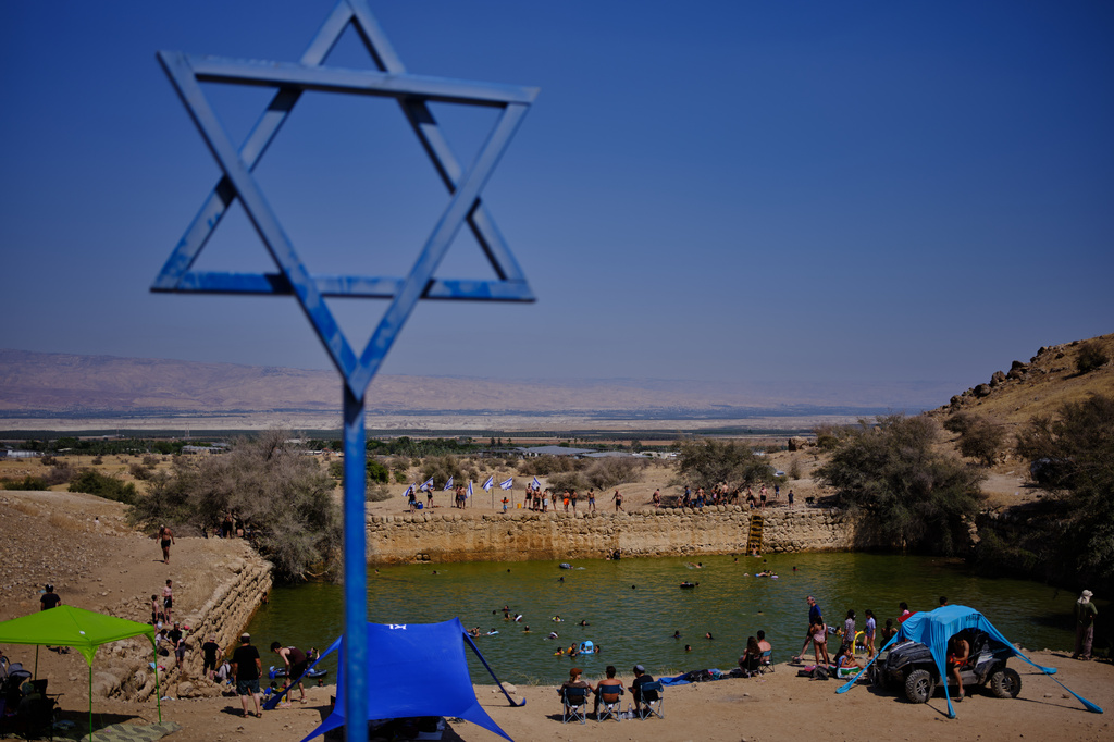 Israelis spend the day at the ancient archaeological site known as Herod's Pool, near the Israeli settlement of Petzael, which was filled with water designated for Palestinian farmland, in the Jordan Valley of the occupied West Bank, on June 19, 2026. (AP Photo/Ohad Zwigenberg)