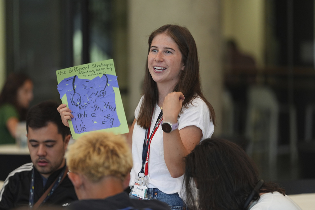 Kathryn Tull of Richmond, Va., explains her project at a workshop during The Neurodiversity Alliance summit on the campus of the University of Denver Friday, Aug. 8, 2025, in Denver. (AP Photo/David Zalubowski)