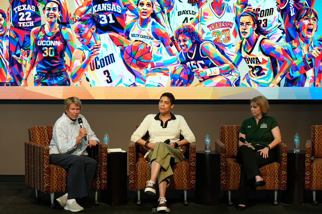 Former Basketball player Ann Meyers Drysdale, left, speaks beside former basketball player Cheryl Miller, center, and Julie Church, Delta State women's basketball assistant coach, during an event Thursday, April 2, 2026, in Phoenix. (AP Photo/John Locher)