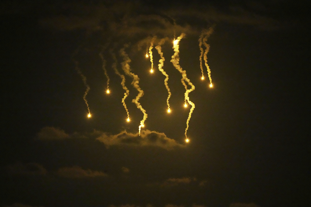 Illumination flares launched by the Israeli army are seen over Deir al-Balah in central Gaza Strip, Wednesday, Sept. 10, 2025. (AP Photo/Abdel Kareem Hana)