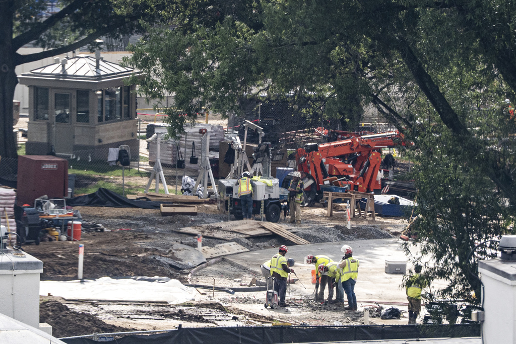 Workers use a jackhammer on the helipad on the South Lawn of the White House, Wednesday, Aug. 5, 2026, in Washington. (AP Photo/Alex Brandon)