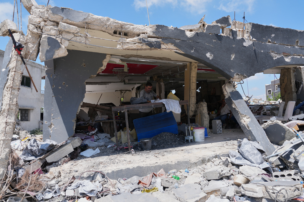 A resident works inside his shop, which was heavily damaged in an Israeli airstrike during the Israel-Hezbollah war,in Ghandouriyeh village, southern Lebanon, Tuesday, July 21, 2026. (AP Photo/Hassan Ammar)