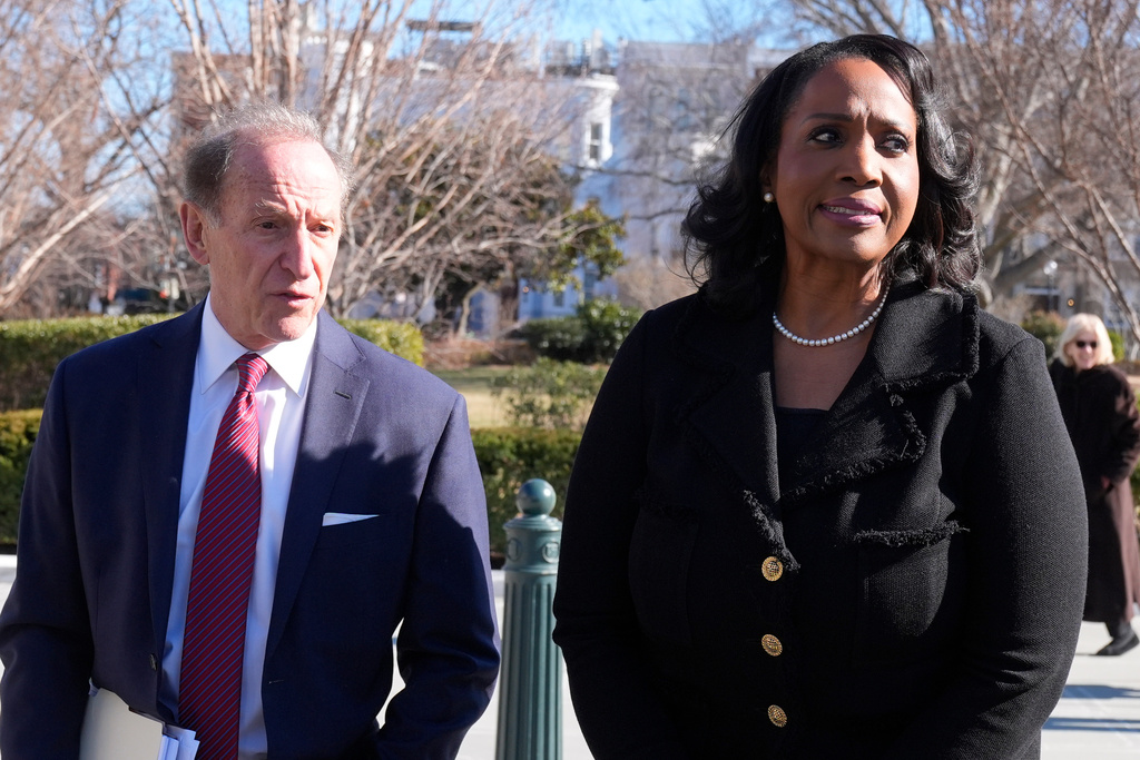 Federal Reserve governor Lisa Cook and attorney Abbe Lowell leave the Supreme Court in Washington, Wednesday, Jan. 21, 2026. (AP Photo/Mark Schiefelbein)