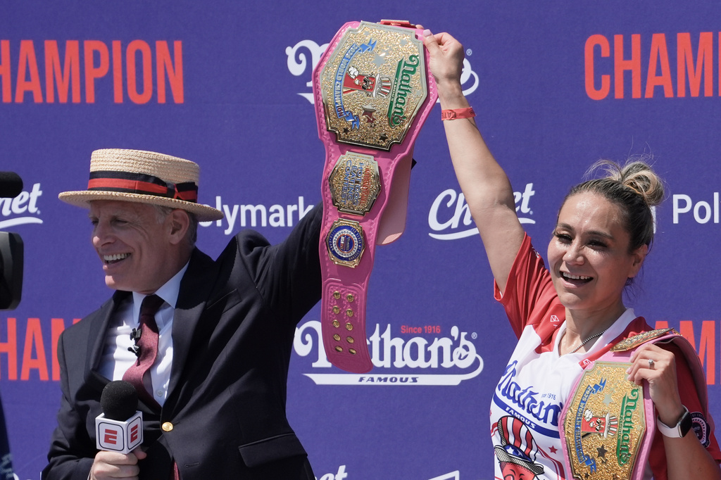 MC George Shea presents competitive eater Miki Sudo with the champion belt after winning the women's 2026 Nathan's Famous Fourth of July hot dog eating contest at Coney Island in the Brooklyn borough of New York, Saturday, July 4, 2026. (AP Photo/Anna Connors)