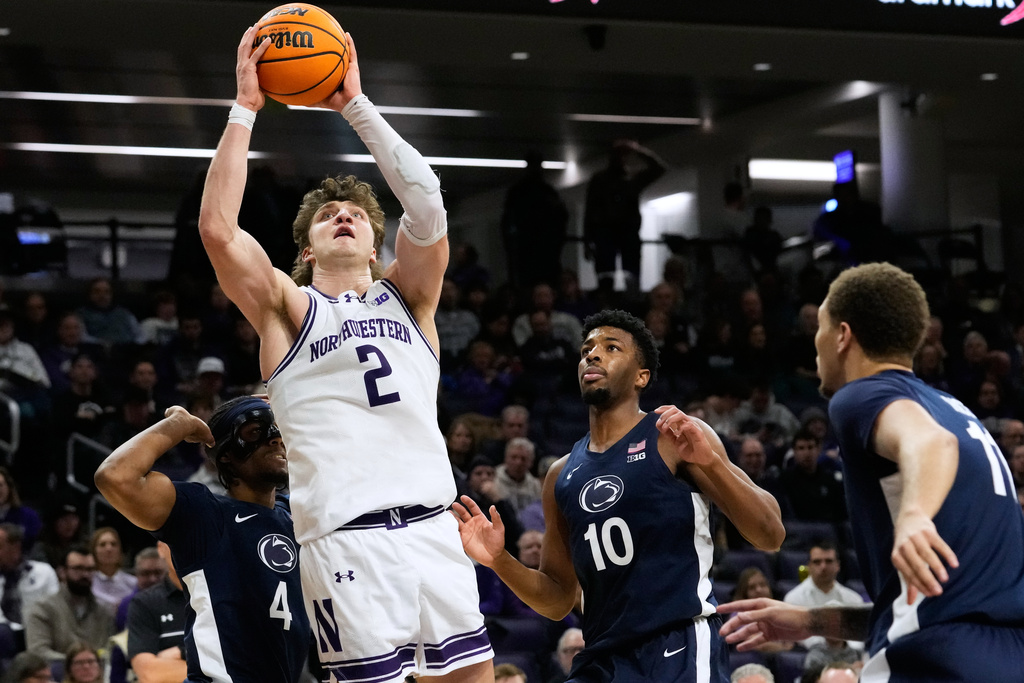 Northwestern forward Nick Martinelli (2) drives to the basket against Penn State guard Kayden Mingo (4), forward Josh Reed (10) and guard Eli Rice (11) during the second half of an NCAA college basketball game in Evanston, Ill., Thursday, Jan. 29, 2026. (AP Photo/Nam Y. Huh)