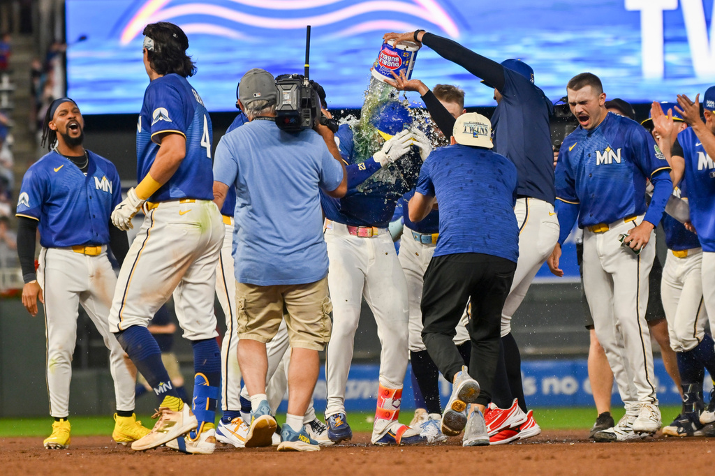 Minnesota Twins' Royce Lewis, center, is doused after hitting a walkoff single against the Colorado Rockies during the 10th inning of a baseball game Friday, June 26 2026, in Minneapolis. (AP Photo/Craig Lassig)