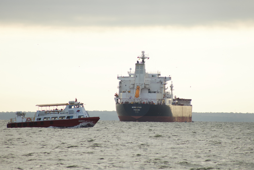 A boat sails past the oil tanker Nord Star, Panama, on Lake Maracaibo, Venezuela, Wednesday, Jan. 7, 2026. (AP Photo/Edgar Frias)