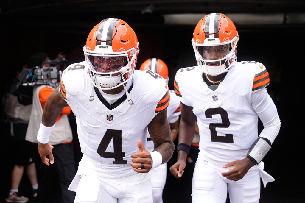 Cleveland Browns quarterback Deshaun Watson (4) and quarterback Shedeur Sanders (2) enter the field to warm up before a preseason NFL football game against the Buffalo Bills, Saturday, Aug. 22, 2026, in Cleveland. (AP Photo/Carolyn Kaster)