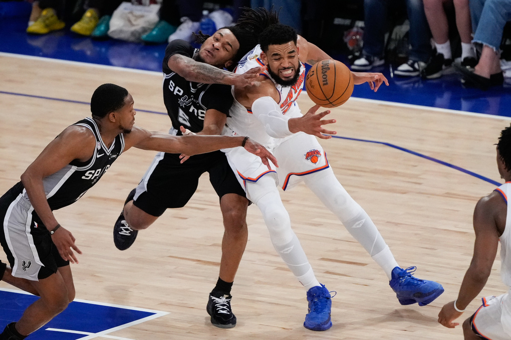New York Knicks center Karl-Anthony Towns, right, and San Antonio Spurs guard Stephon Castle (5) battle for the ball during the second half of Game 4 of the NBA Finals basketball series, Wednesday, June 10, 2026, in New York. (AP Photo/Ross D. Franklin)