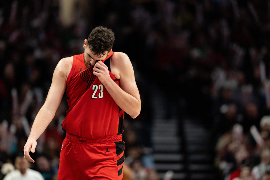 Portland Trail Blazers center Donovan Clingan wipes away his sweat during the second half of an NBA basketball against the Orlando Magic game Tuesday Dec. 23, 2025, in Portland, Ore. (AP Photo/Howard Lao)