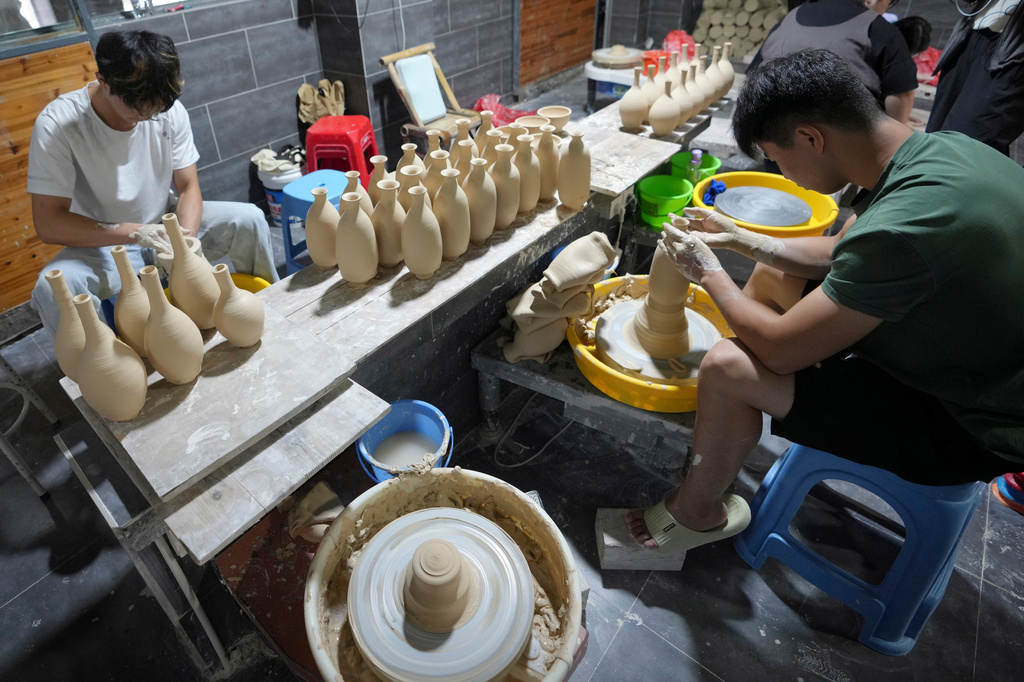 Students practice traditional ceramic craftsmanship at Zhan Shao Ceramic Arts Practice Base in Jingdezhen, known as China's "Porcelain Capital," in eastern China's Jiangxi province, Tuesday, Sept. 1, 2026. (AP Photo/Achmad Ibrahim)