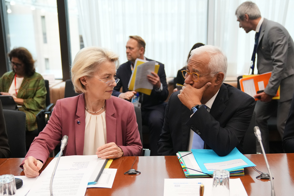 European Commission President Ursula von der Leyen, left, and European Council President Antonio Costa wait for the start of the Tripartite Social Summit at the European Council building in Brussels, Wednesday, Oct. 22, 2025. (AP Photo/Virginia Mayo)