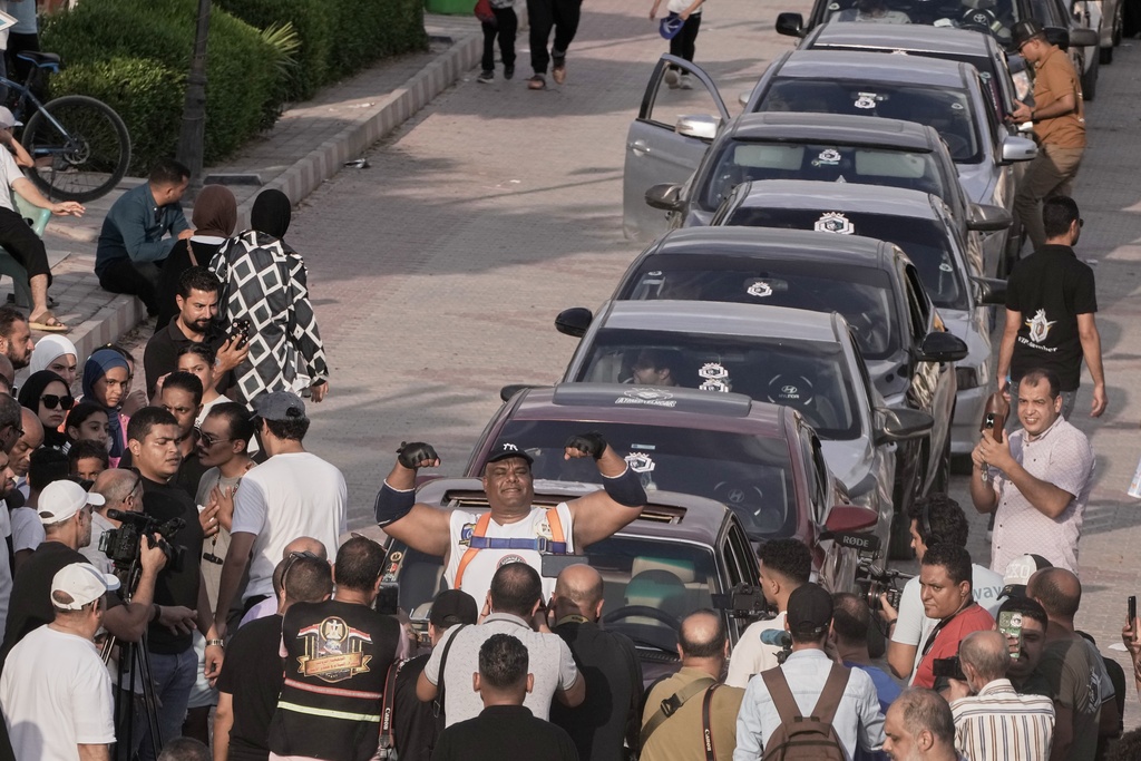 Egyptian wrestler Ashraf Mahrous, also known by his nickname Kabonga, celebrates after attempting to pull 20 vehicles at Al Safaa Club in 10th of Ramadan City, outside Cairo, Egypt, Friday, Aug. 1, 2025. (AP Photo/Amr Nabil)