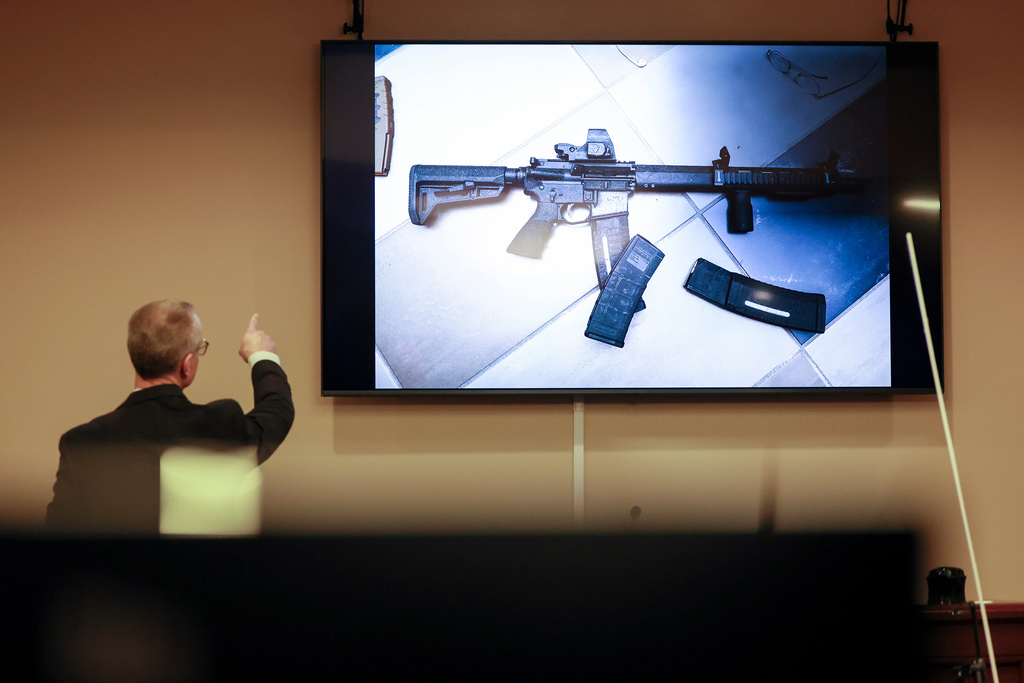 District Attorney Brad Smith, left, points to a weapon that was displayed on the screen during the first day of the trial of Colin Gray, the father of Apalachee High School shooting suspect Colt Gray, in the courtroom at the Barrow County courthouse, Monday, Feb. 16, 2026, in Winder, Ga. (Jason Getz/Atlanta Journal-Constitution via AP)