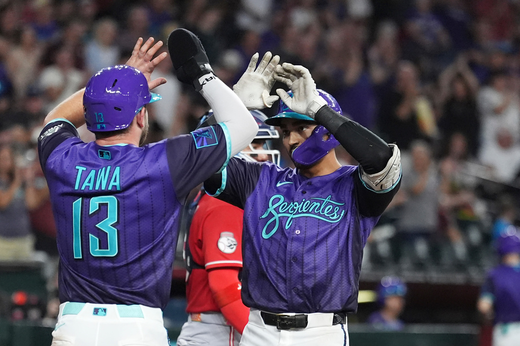 Arizona Diamondbacks' Jordan Lawlar, right, celebrates his two-run home run against the Cincinnati Reds with Diamondbacks' Tim Tawa (13) during the second inning of a baseball game, Friday, Aug. 21, 2026, in Phoenix. (AP Photo/Ross D. Franklin)