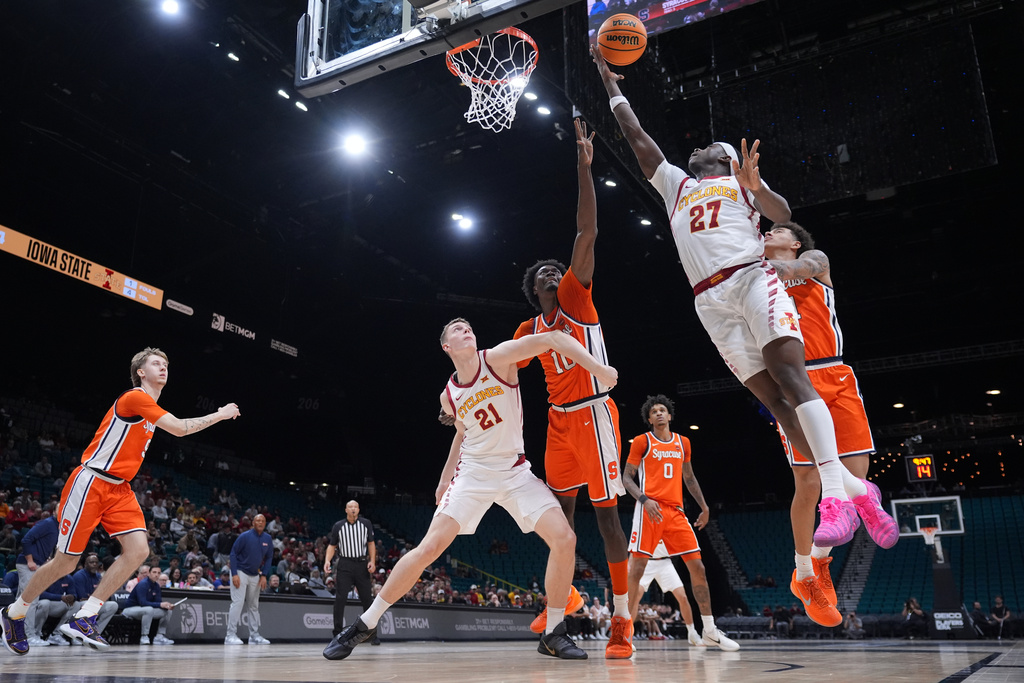 Iowa State guard Killyan Toure (27) drives to the basket over Syracuse forward Ibrahim Souare (10) during the first half of an NCAA college basketball game in the Players Era tournament in Las Vegas, Wednesday, Nov. 26, 2025. (AP Photo/Eric Gay)