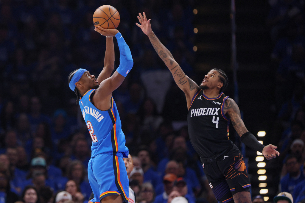 Oklahoma City Thunder guard Shai Gilgeous-Alexander (2) looks to shoot over Phoenix Suns guard Jalen Green (4) during the first half in Game 1 of a first-round NBA playoffs basketball series Sunday, April 19, 2026, in Oklahoma City. (AP Photo/Nate Billings)