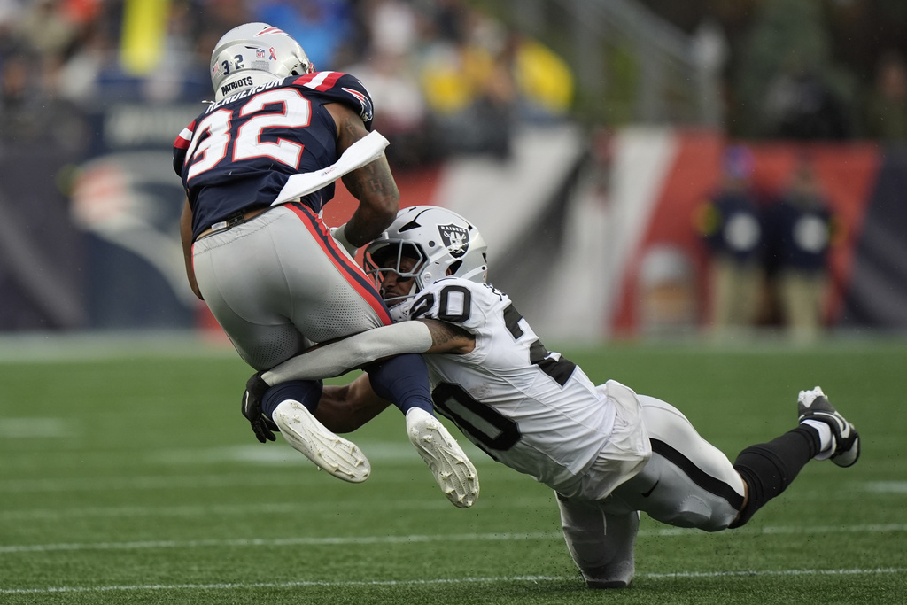 Las Vegas Raiders safety Isaiah Pola-Mao (20) tackeles New England Patriots running back TreVeyon Henderson (32) during the second half of an NFL football game, Sunday, Sept. 7, 2025, in Foxborough, Mass. (AP Photo/Robert F. Bukaty)