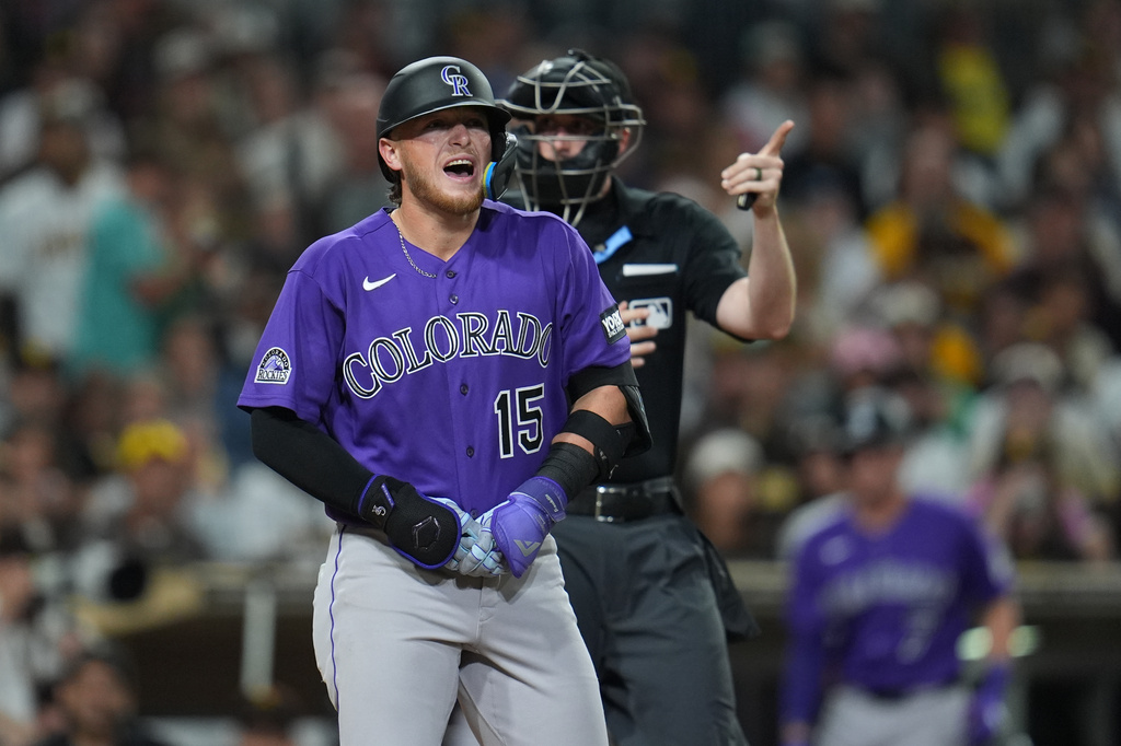 Colorado Rockies' Hunter Goodman (15) holds hand after getting hit by a pitch while batting during the sixth inning of a baseball game against the San Diego Padres Thursday, April 9, 2026, in San Diego. (AP Photo/Gregory Bull)