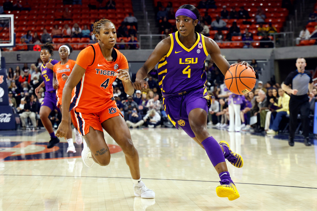 LSU guard Flau'jae Johnson, right, drives to the basket around Auburn guard Kaitlyn Duhon, left, during the first half of an NCAA college basketball game Sunday, Feb. 8, 2026, in Auburn, Ala. (AP Photo/Butch Dill)