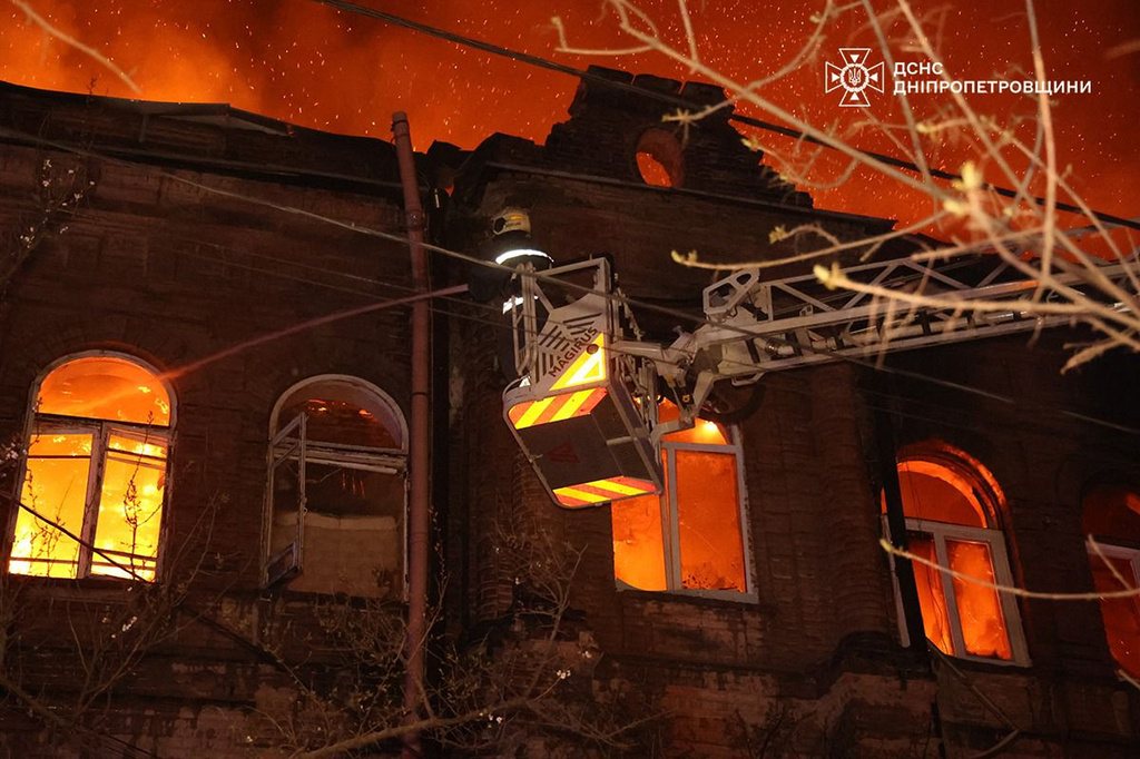 In this photo provided by the Ukrainian Emergency Service, firefighters put out a fire following a Russian attack in Dnipro, Ukraine, Thursday, April 16, 2026. (Ukrainian Emergency Service via AP)