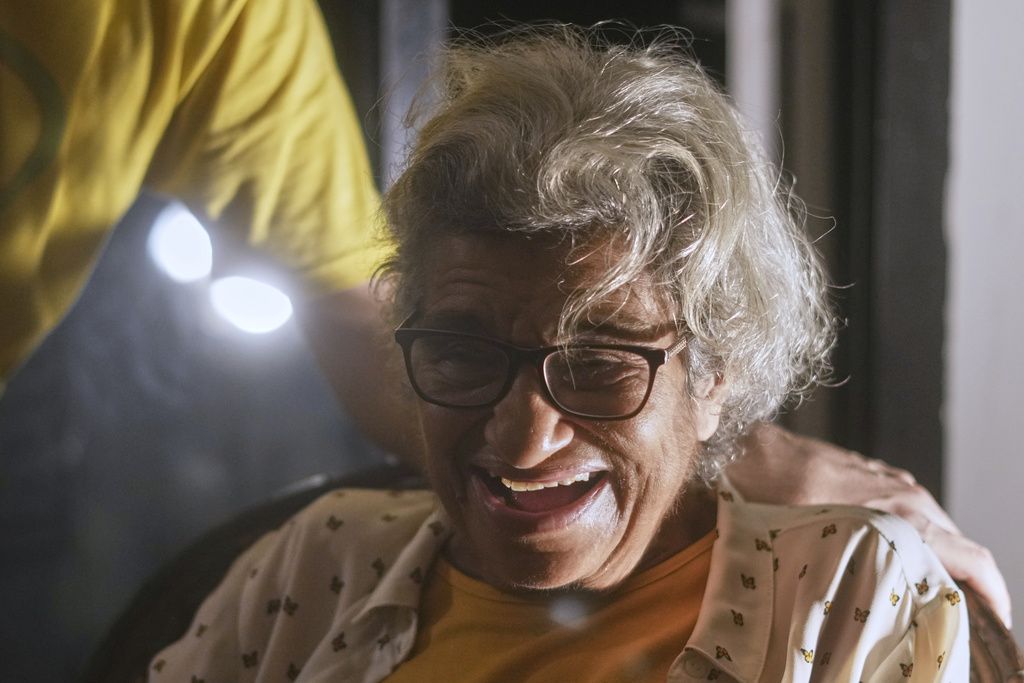 Laila Soueif, the mother of pro-democracy Egyptian-British activist Alaa Abd el-Fattah, who was in prison for almost all of the past 12 years, smiles as she meets her son at home, after a presidential pardon, in Cairo, Egypt, Tuesday, Sept. 23, 2025. (AP Photo/Amr Nabil)