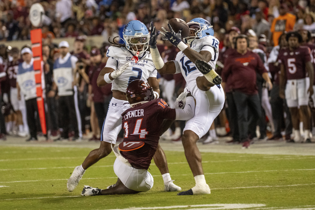 Old Dominion safety Jerome Carter (12) intercepts the ball against Virginia Tech during the first half of an NCAA college football game Saturday, Sept. 13, 2025, in Blacksburg, Va. (AP Photo/Robert Simmons)